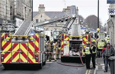  ?? Photograph­s: Colin Rennie ?? UNDER CONTROL: Six appliances tackled the fire in a Chinese takeaway in Huntly.