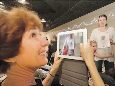  ?? PHOTOS: GREG PENDER/The StarPhoeni­x ?? Anastasia Kougiya, right, says Canada is a much better place to raise a child than her homeland of Russia. Her daughter, Julia, was born in Canada. One hundred and fifty people from 31 countries were officially welcomed as new citizens to
Canada in a...