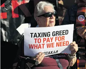  ?? Genaro Molina Los Angeles Times ?? SISTER Diane Smith, of Clergy and Laity United for Economic Justice, joins an event last month announcing the tax initiative.
