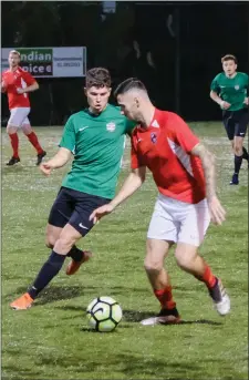  ??  ?? Michael O’Brien of Greystones United closes in on Robbie McCourt of Tolka Rovers.