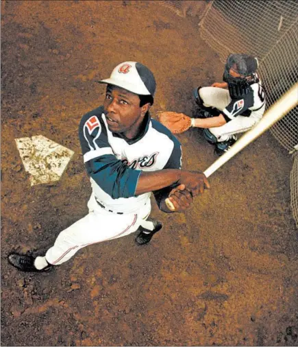  ?? AP ?? Atlanta Braves outfielder Hank Aaron takes a swing during spring training in 1974. Aaron died Friday at 86.