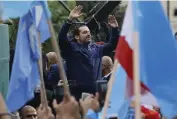  ??  ?? Lebanese prime minister Saad Hariri greets his supporters in Beirut during national day ceremonies yesterday