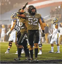  ?? ADAM HUNGER AP ?? Oceanside High’s Amadeo West (52) made a big goal-line stop to help Army beat Navy. The Black Knights will take on Tennessee in the Liberty Bowl on Thursday.