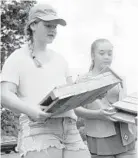  ?? DAVID ANDERSON/BALTIMORE SUN MEDIA GROUP ?? Fallston Girl Scout Sarah Kuehn, left, talks about the bat boxes she and fellow Scout Lily Knudsen, right, made for their Silver Award project. The boxes were installed at Edgeley Grove Farm in Fallston.