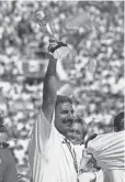  ?? MICHAEL CAULFIELD, AP ?? Coach Tony DiCicco hoists the World Cup trophy his U. S. women’s team won in 1999.