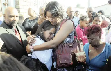  ?? PICTURE: BERTRAM MALGAS ?? DISTRAUGHT: Rene Tracy Roman’s mother, Chrissandr­e Jacobs, cries as the casket leaves the church. Her body was laid to rest at the Muizenberg cemetery on Saturday morning.