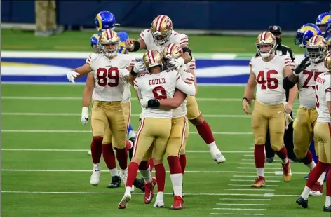  ?? AP PHOTO/KELVIN KUO ?? San Francisco 49ers kicker Robbie Gould (9) is hugged by teammates after making the game-winning field goal as time expires during the second half of an NFL football game against the Los Angeles Rams Sunday in Inglewood, Calif. San Francisco won 23-20.