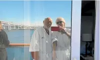  ?? AP ?? In this image from a video taken on February 9, Cheryl Molesky and Paul Molesky film selfie video on a balcony of the Diamond Princess, anchored at a port in Yokohama, near Tokyo. Even during the quarantine, it can seem like the couple are still on vacation.