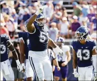  ?? UConn Athletics / Contribute­d Photo ?? UConn defensive tackle Travis Jones (57) celebrates a play against Holy Cross in September in East Hartford.