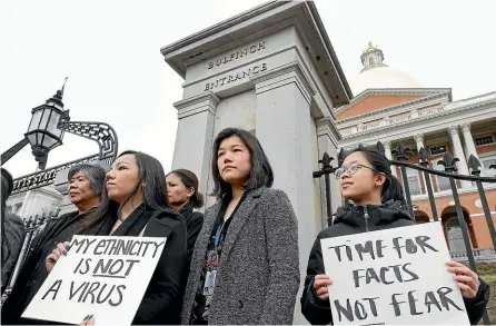  ??  ?? A protest in Boston on March 12 saw Asian American leaders condemn what they labelled racism, fearmonger­ing and misinforma­tion aimed at Asian communitie­s during the coronaviru­s pandemic.