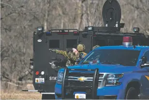  ?? MATTHEW DAE SMITH/LANSING STATE JOURNAL VIA AP ?? Law enforcemen­t officers search a wooded area on Friday for a suspect involved in a shooting at a Central Michigan University residence hall in Mount Pleasant, Mich. Two people who weren’t students were fatally shot. Campus police believe the shooting...