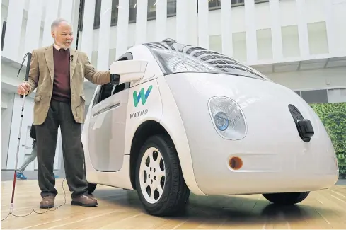  ?? AP ?? Steve Mahan, who is blind, stands by the Waymo driverless car during a Google event in San Francisco on Tuesday.