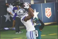  ?? The Associated Press ?? TOUCHDOWN: Dallas Cowboys wide receiver Michael Gallup (13) catches a touchdown pass as Philadelph­ia Eagles cornerback Michael Jacquet (38) defends in the first half of Sunday’s game in Arlington, Texas.