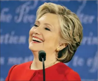  ?? JULIO CORTEZ — THE ASSOCIATED PRESS ?? Democratic presidenti­al nominee Hillary Clinton laughs to Republican presidenti­al nominee Donald Trump during the presidenti­al debate at Hofstra University in Hempstead, N.Y., Monday.