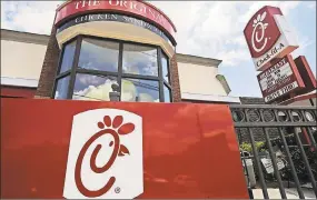  ?? Mike Stewart / Associated Press file photo ?? ChickfilA is ending donations to three groups that oppose gay marriage in an effort to halt protests and broaden its customer base.