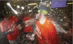  ?? JULIO CORTEZ — THE ASSOCIATED PRESS ?? Baltimore Orioles starting pitcher Grayson Rodriguez is doused by teammates while celebratin­g their team's AL East championsh­ip Thursday.