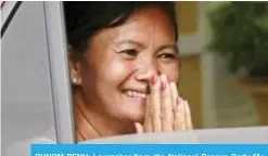  ?? — AP ?? PHNOM PENH: Lawmaker from the National Rescue Party Mu Sochua smiles from her car window. Mu Sochua has fled the country.