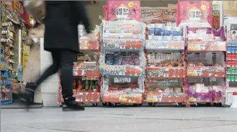  ?? PICTURE: REUTERS ?? BUSINESS GROWS: A shopper outside a discount shop in Tokyo. Japanese consumer inflation accelerate­d to a five-year high and the price index grew at its fastest in 15 years, more evidence that Japan’s aggressive policies are working.