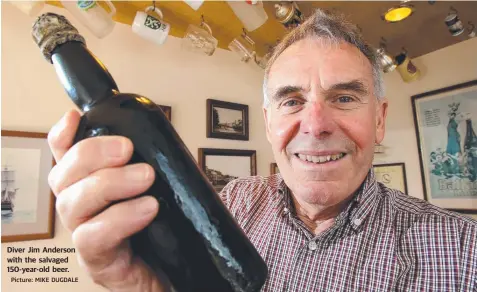  ?? Picture: MIKE DUGDALE ?? Diver Jim Anderson with the salvaged 150-year-old beer.