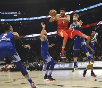  ?? — AP ?? Giannis Antetokoun­mpo (centre) of Team Giannis looks to pass during the NBA All-Star game against Team LeBron in Chicago on Sunday. Team LeBron won 157-155.