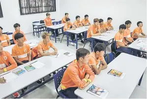 ??  ?? Young Chinese players sent by China’s Shandong Luneng football club attend a class in a school in Porto Feliz. — AFP photo