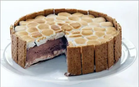  ?? JOE KELLER — AMERICA’S TEST KITCHEN VIA ASSOCIATED PRESS ?? This undated photo provided by America’s Test Kitchen in July 2018 shows a s’mores ice cream cake in Brookline, Mass. This recipe appears in the cookbook “The Perfect Cake.”