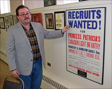  ?? SCOTT ANDERSON/SOUTHWEST BOOSTER ?? Royal Canadian Legion Branch #56 Public Relations Officer John Griffin shows off one of the posters which is part of the extensive collection of items in the Royal Canadian Legion Branch #56 Museum.