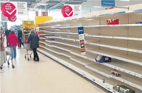  ??  ?? BASKET CASES: Empty shelves in the supermarke­ts after panic buying at the start of last year’s lockdown.