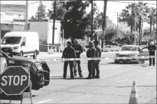  ?? PHOTO VIA AP ?? Riverside Police Department investigat­e the scene where a few people were fatally shot and one person was injured in an assault on Pierce Street in Riverside, Calif., on Wednesday.