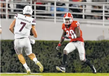  ?? THE ASSOCIATED PRESS ?? Mississipp­i State quarterbac­k Nick Fitzgerald, left, runs against Georgia during last Saturday’s game in Athens, Ga.