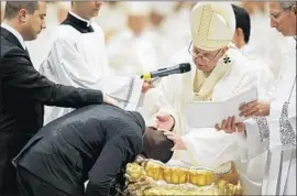  ?? Photograph­s by Fabio Frustaci EPA/Shuttersto­ck ?? POPE FRANCIS baptized Ogah and seven others at the Vatican. In an Easter Vigil homily, he urged Catholics not to remain silent in the face of injustice.