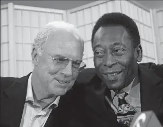  ?? JASON DECROWAP PHOTO ?? In this April 7, 2006, file photo, soccer legends Franz Beckenbaue­r, left, and Edson Arantes Do Nascimento, known as Pele, embrace during a news conference in New York.