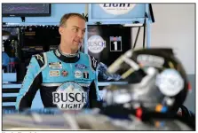  ??  ?? Kevin Harvick gets ready for a NASCAR auto race practice in his garage at Daytona Internatio­nal Speedway on Saturday in Daytona Beach, Fla. (AP/Terry Renna)