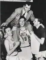  ?? Sporting News Archive ?? Minneapoli­s Lakers head coach John Kundla is hoisted onto center George Mikan’s shoulders by Slater Martin (left) and Stanford alum Jim Pollard.