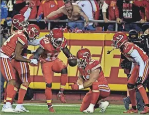  ?? [ASSOCIATED PRESS/ED ZURGA] ?? Tyreek Hill and Chiefs teammates provided a quality shoutout to NASCAR with this simulated pit stop as TD celebratio­n.