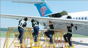  ?? JIANG BING / XINHUA ?? Technician­s take part in a plane repair contest at the China Southern Airlines’ maintenanc­e and engineerin­g base in Shenyang, Liaoning province.