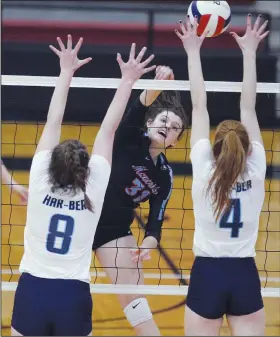  ?? Arkansas Democrat-Gazette/THOMAS METTHE ?? Fort Smith Southside’s Bailey Vega (31) hits the ball past Springdale Har-Ber’s Mackenzie White (8) and Faith Donnell (4) during the Class 6A state volleyball tournament semifinal on Thursday in Cabot.