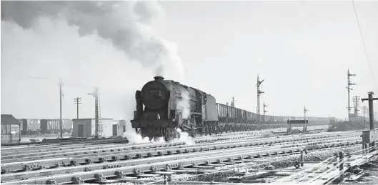  ?? S C Crook/ARPT ?? Photograph­er Stanley Crooks must surely have been ‘in the know’ to be braving the elements at Petteril Bridge Junction when Rebuilt ‘Patriot’ class 4-6-0 No 45530 Sir Frank Ree exited the Newcastle & Carlisle line on a rake of hoppers in late December 1965. Most likely an engine change rather than a trip from Newcastle, perhaps this was the locomotive’s concluding duty. It would be withdrawn from Kingmoor shed on 31 December. Whilst the sight of 21-ton hoppers arriving from the Blaydon direction was regular fare at this location, and ‘Patriots’ were a possible (though not especially common) sighting on the Settle & Carlisle line – the route across the view in the foreground – we seem to have a meeting of these two possibilit­ies. The working is believed to be a throwback to Stainmore route days and the Derwenthau­gh-Millom coke duties, although it seems to be empty wagons so is perhaps a positionin­g move to Millom for a future diesel-worked job. Back on 2 December 1959 it was recommende­d that through freight workings over the Stainmore route be stopped (it closed as a through route in January 1962) and that they should instead be routed via the Tyne Valley (N&C) route. Originally coke went west from
Derwenthau­gh to Millom and the return trains brought iron ore to Teesside.