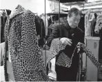  ??  ?? Lin looks over a 60-year-old cheetah jacket he was restoring at the B.B. Hawk showroom in San Francisco on Friday.