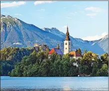  ?? Rick Steves’ Europe/DOMINIC ARIZONA BONUCCELLI ?? One popular Ljubljana day trip is a visit to Lake Bled, with its iconic churchtopp­ed island ringed by monumental peaks.