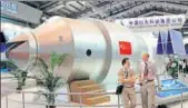  ?? AP FILE ?? Visitors in front of a model of China's Tiangong1 space station at an aviation and aerospace exhibition in Guangdong.