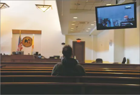  ?? WILL HOOPER/Taos News ?? A man looks on as Sgt. Bennett testifies at the Colfax County Judicial Center in Raton is livestream­ed to the Taos County Courthouse.