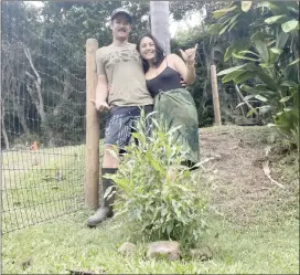  ?? Photo courtesy Rodrigues family ?? Kely and Lindsay Rodrigues pose in front of a newly planted aalii on their Waihee Valley property. To them, planting native is not only a way to restore a native landscape from dominant invasive weeds, but cultivate a connection to their culture, kupuna and place and ensure that future generation­s experience that connection, too.