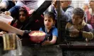  ?? ?? Displaced Palestinia­ns queue to receive food in Rafah. Photograph: Anadolu/Getty Images