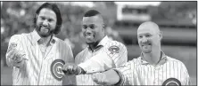  ?? AP/CHARLES REX ARBOGAST ?? Former Chicago Cubs players Jason Hammel (from left), Jorge Soler and Travis Wood (Bryant) display their World Series rings after Monday’s ceremony.