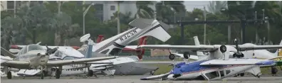  ?? ?? Grounded: Light aircraft were flipped over and smashed at North Perry Airfield near Miami