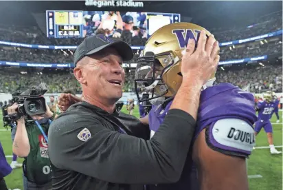  ?? KIRBY LEE/USA TODAY SPORTS ?? Washington head coach Kalen DeBoer and quarterbac­k Michael Penix Jr. (9) celebrate after the Pac-12 championsh­ip game. DeBoer is an SD native and previously coached at the University of Sioux Falls.