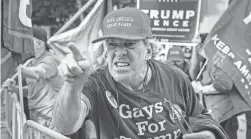  ?? JOHN MINCHILLO/AP ?? A supporter of President Donald Trump shouts at celebratin­g demonstrat­ors after the election is called for Joe Biden in Philadelph­ia.