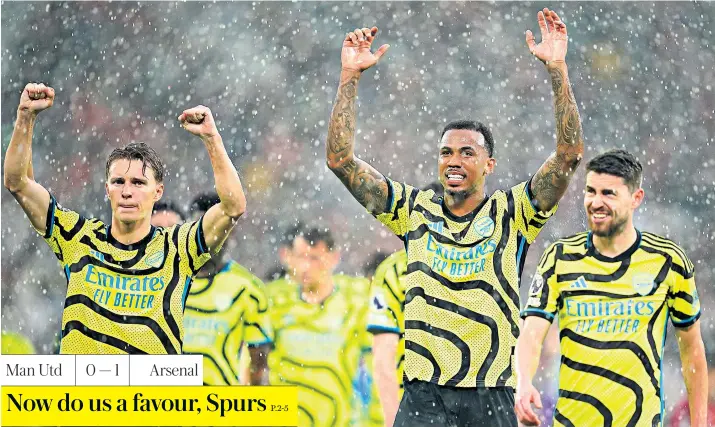  ?? ?? Job done: Arsenal players celebrate after victory at a wet Old Trafford