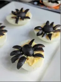  ??  ?? Sliced black olives turn a standard deviled egg into one that looks like a spider.